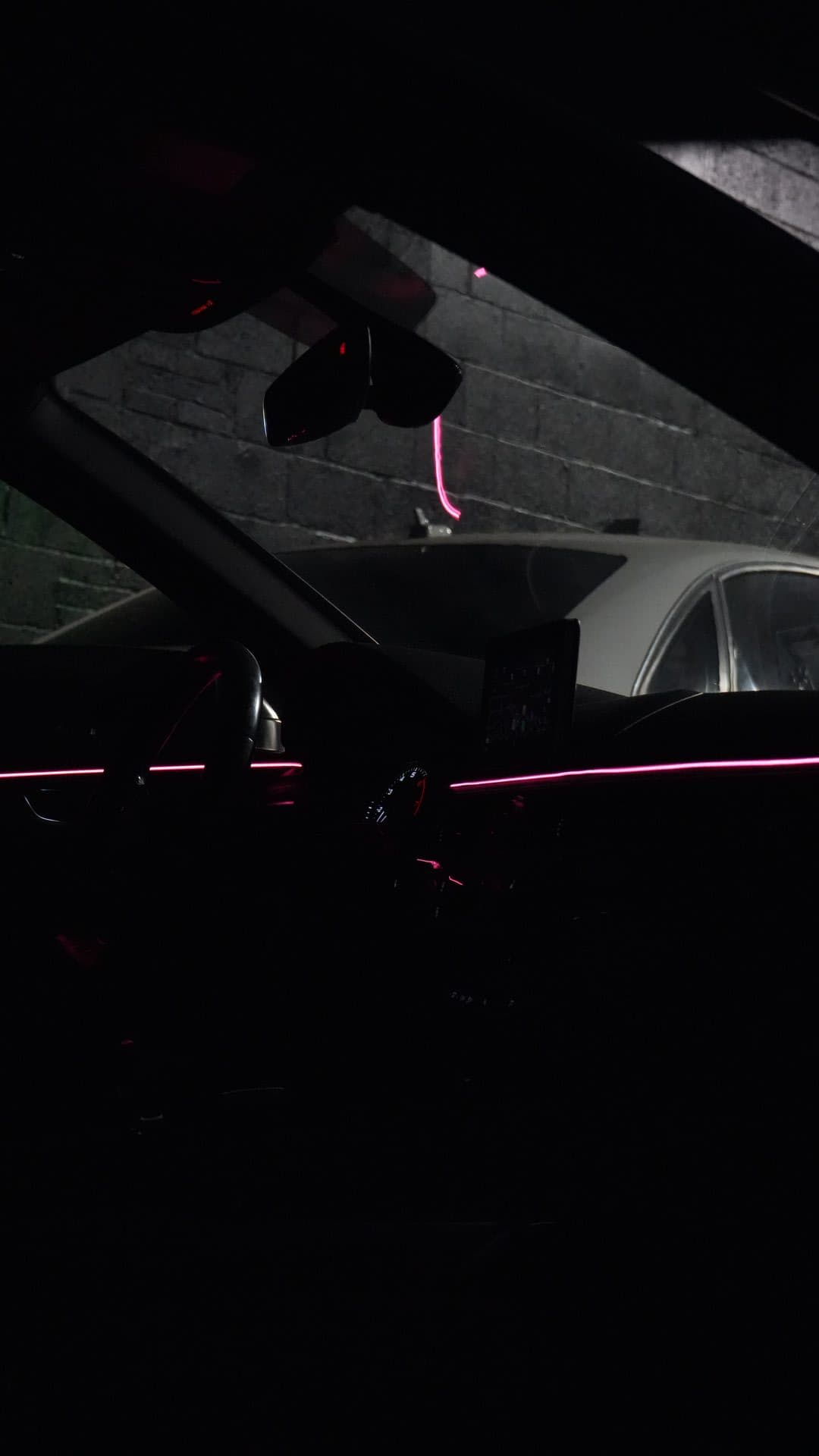 Audi — pink ambient strip, cockpit at night outside