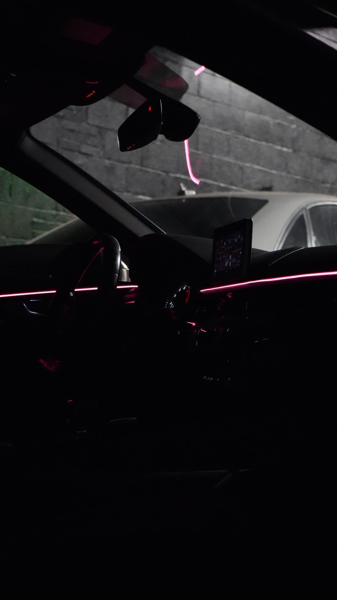 Audi — pink/red ambient strips, cockpit from door